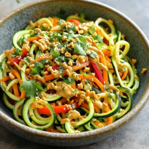 You need fresh and vibrant veggies for this dish. Here’s what you will need: - 4 medium zucchinis - 1 cup carrots, julienned - 1 red bell pepper, thinly sliced - 1/2 cup green onions, thinly sliced - 1/2 cup roasted peanuts, roughly chopped - 1/4 cup fresh cilantro, chopped (for garnish) - 2 tablespoons sesame oil These ingredients provide a colorful base. The zucchinis give a soft bite. The carrots and bell pepper add crunch and sweetness. The peanut sauce is the star of this dish. It adds rich flavor. Gather these ingredients: - 1/3 cup creamy peanut butter - 3 tablespoons low-sodium soy sauce - 2 tablespoons fresh lime juice - 1 tablespoon honey or maple syrup - 1 tablespoon fresh ginger, grated - 2 garlic cloves, minced - 1-2 tablespoons water (to thin the sauce, as needed) The creamy peanut butter makes the sauce smooth. Lime juice adds a nice tang. Honey or maple syrup balances the flavors. Garnishes make your dish look pretty and inviting. Here are my top picks: - Sliced green onions - Rough-chopped peanuts - Fresh cilantro These toppings add texture and flavor. They also make your meal pop with color. You can also add a lime wedge for an extra splash of zest. To start, wash the zucchinis well and cut off the ends. Then, use a spiralizer to make long noodle-like strands. If you don’t have a spiralizer, a vegetable peeler can help you create flat ribbons. Place the zucchini noodles in a large mixing bowl and set them aside. In a medium bowl, mix together the creamy peanut butter, low-sodium soy sauce, lime juice, honey or maple syrup, grated ginger, and minced garlic. Whisk until the mixture is smooth and well combined. If the sauce is too thick, add 1 to 2 tablespoons of water to make it easier to pour. Heat 2 tablespoons of sesame oil in a large skillet over medium heat. Once the oil shimmers, add the julienned carrots and thinly sliced red bell pepper. Sauté the veggies for about 3 to 4 minutes. You want them soft but still crunchy. Carefully add the zucchini noodles to the skillet with the cooked vegetables. Pour the peanut sauce over everything. Gently toss to coat the noodles and veggies in the sauce. Cook for an additional 2 to 3 minutes, just enough to warm it all through. Make sure the zucchini stays al dente. When you're done, transfer the noodles to bowls. Top with sliced green onions, rough-chopped peanuts, and fresh cilantro for garnish. Enjoy your colorful and tasty dish! To make great zucchini noodles, start by picking fresh zucchinis. Look for firm ones with smooth skin. Wash them well and cut off the ends. A spiralizer works best for creating long noodles. If you don't have one, a vegetable peeler will do. Just slice thin ribbons. After spiraling or peeling, place the noodles in a bowl and set aside. This helps them stay crisp and fresh. Getting the right peanut sauce texture is key. Start with creamy peanut butter in a bowl. Mix in soy sauce, lime juice, honey, ginger, and garlic. Whisk until smooth. If it feels too thick, add water bit by bit. This helps you reach a pourable sauce. A good sauce coats the noodles well without being runny. When cooking the vegetables, don't rush it. Heat sesame oil in a skillet until it shimmers. Add carrots and bell peppers first. Sauté for 3 to 4 minutes. They should be soft but still crunchy. Next, add the zucchini noodles. Toss everything together gently to coat with sauce. Cook for just 2 to 3 more minutes. You want the zucchini to stay firm and not mushy. Enjoy your dish warm and fresh! {{image_4}} You can add protein to make this dish heartier. If you like chicken, use thin strips of cooked chicken breast. For a plant-based option, tofu works great. Just press the tofu to remove water, then cube and sauté until golden. Shrimp is another tasty choice. Sauté shrimp until pink and tender. Mix your chosen protein in with the noodles and veggies for a complete meal. Feel free to play with veggies. Broccoli florets add crunch and color. Snap peas bring a sweet taste and bright green look. You could also add sliced mushrooms for an earthy flavor. Toss in baby spinach for a fresh touch. Remember, the more colorful your plate, the more appealing it looks! If you have allergies, don't worry! You can swap peanut butter for sunflower seed butter if you're nut-free. For soy sauce, consider coconut aminos for a soy-free option. Honey can be replaced with agave syrup for a vegan choice. Always read labels to ensure your substitutes are safe for your needs. To keep your Thai peanut zucchini noodles fresh, place them in an airtight container. Make sure to cool them to room temperature first. Store in the fridge for up to three days. This helps maintain the taste and texture. While freezing is an option, it can change the texture of the zucchini noodles. If you want to freeze them, store the noodles and sauce separately. Use freezer-safe bags or containers. They can last for up to two months in the freezer. Just remember to label them clearly. To reheat, use a skillet over medium heat. Add a splash of water or oil to keep them moist. Heat for about five minutes or until warm. You can also microwave them in a bowl covered with a damp paper towel. Heat in short bursts of 30 seconds, stirring in between, until hot. Yes, you can make this dish vegan. Simply swap honey for maple syrup. Use low-sodium soy sauce that is vegan. Ensure your peanut butter has no added animal products. To enhance flavors, add lime zest for freshness. Consider adding a splash of rice vinegar for tang. You can also mix in a bit of sriracha for heat or fresh herbs like mint. Yes, meal prepping is easy with this recipe. Prepare the zucchini noodles and sauce in advance. Store them separately in airtight containers. Combine them just before serving for best taste and texture. Zucchini noodles are low in calories and high in fiber. They provide vitamins A and C, which support eye health and immunity. Zucchini also contains antioxidants, making it a healthy choice. To adjust spiciness, add more or less sriracha to the sauce. You can also sprinkle red pepper flakes on top for extra heat. If you prefer less spice, reduce the amount of garlic or ginger. This blog covered how to make tasty Thai peanut zucchini noodles. You learned about key ingredients, step-by-step instructions, and helpful tips. Variations let you add protein or customize flavors. Proper storage keeps leftovers fresh. These noodles are healthy, fun, and easy to change. Experiment with your favorite veggies or spices. Enjoy your cooking and impress your taste buds!